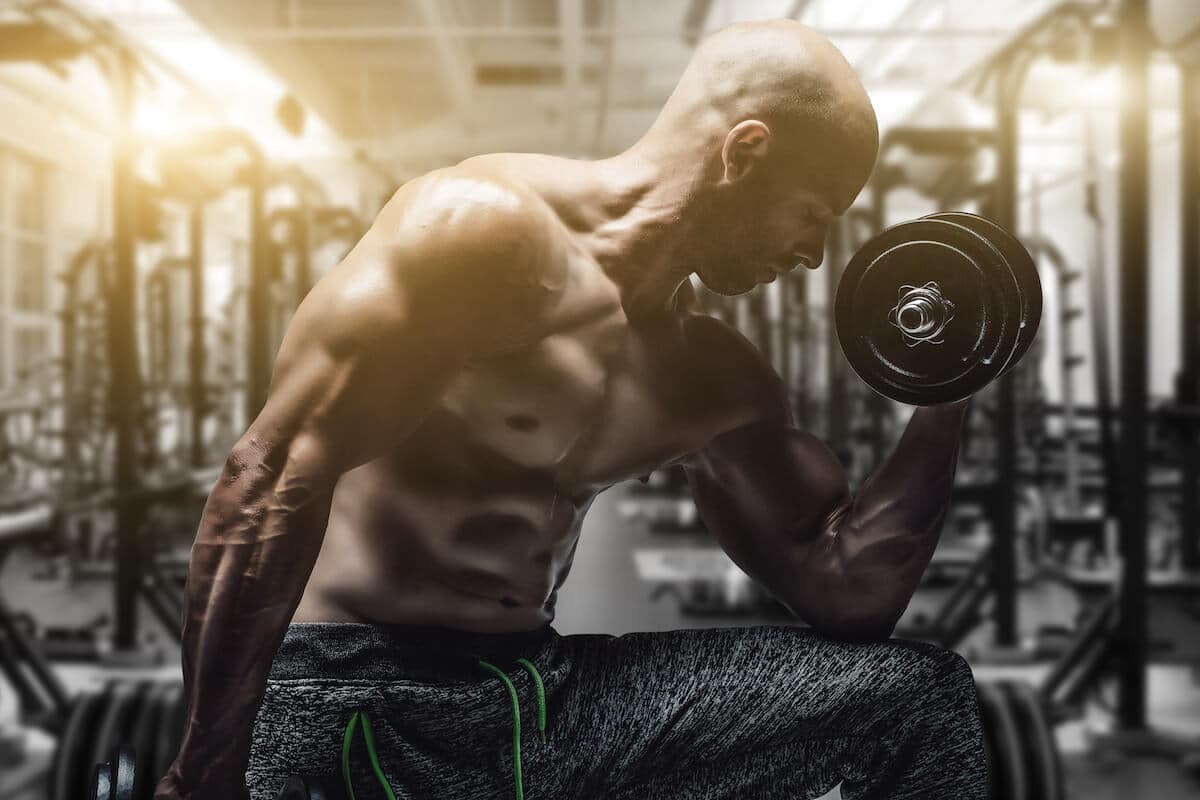 Bodybuilder exercising his arms with weights