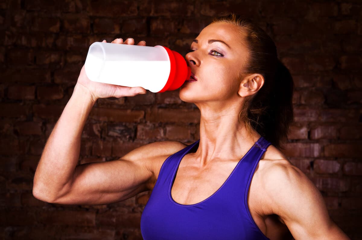 Fit woman drinking from a tumbler