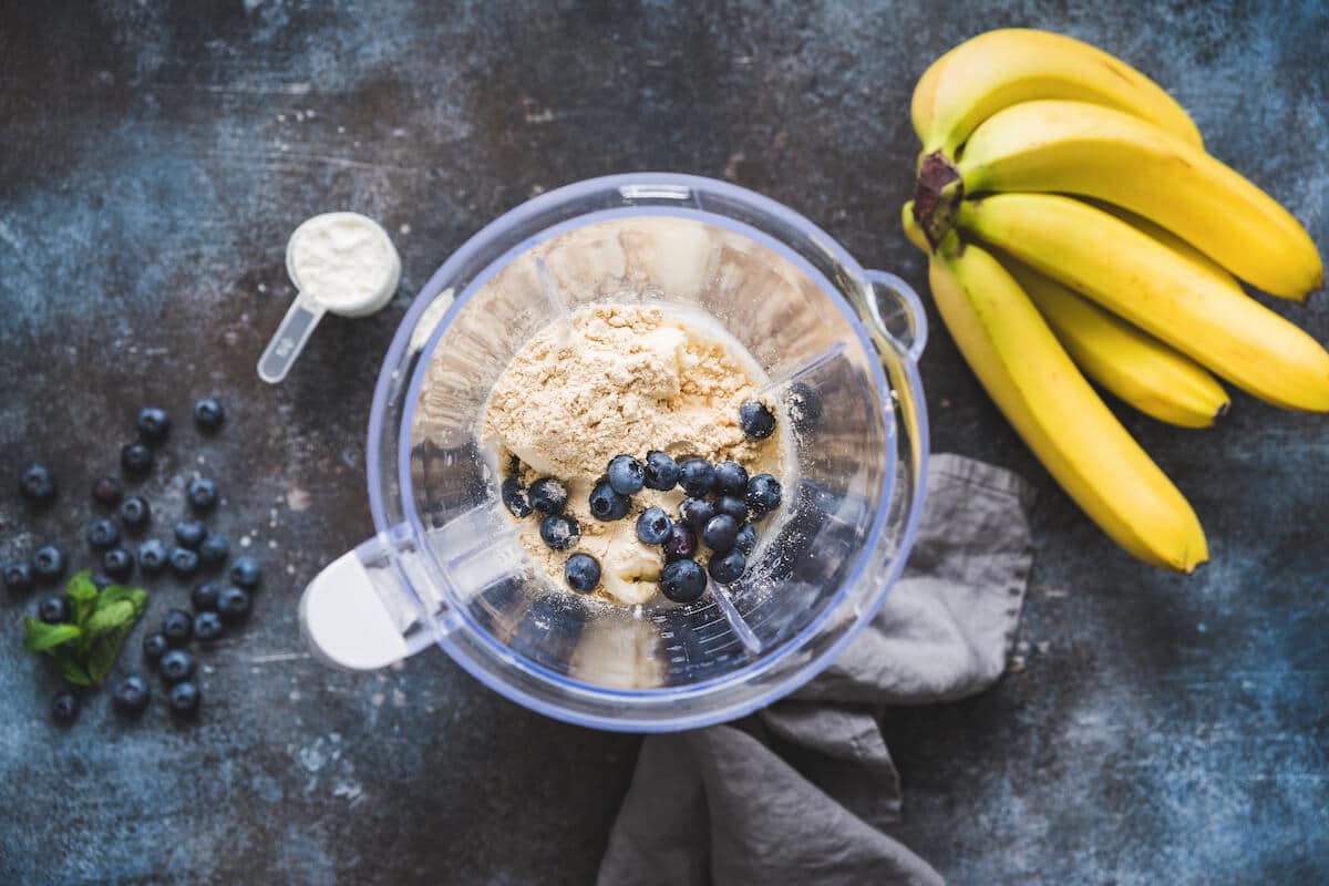 Protein shakes for weight gain: blueberries, bananas, and protein powder in a blender