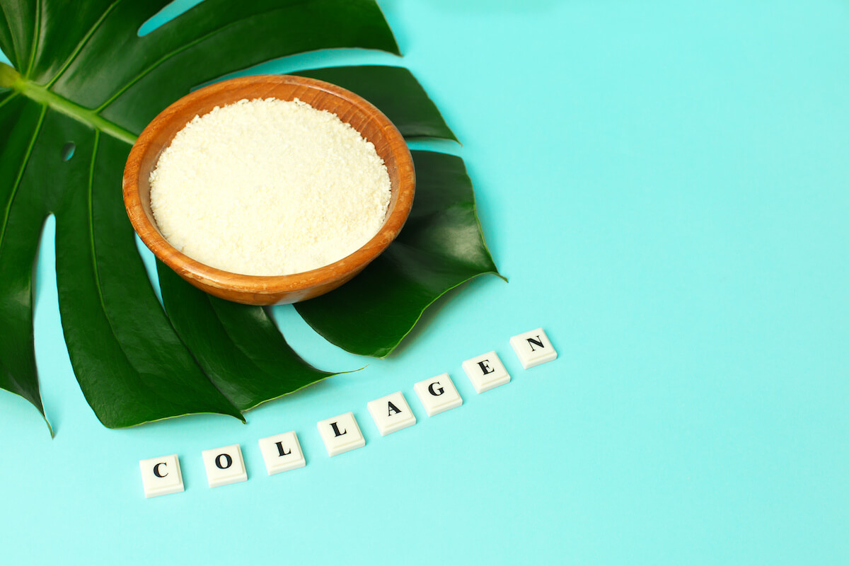 Collagen in a wooden bowl and COLLAGEN spelled using scrabble tiles