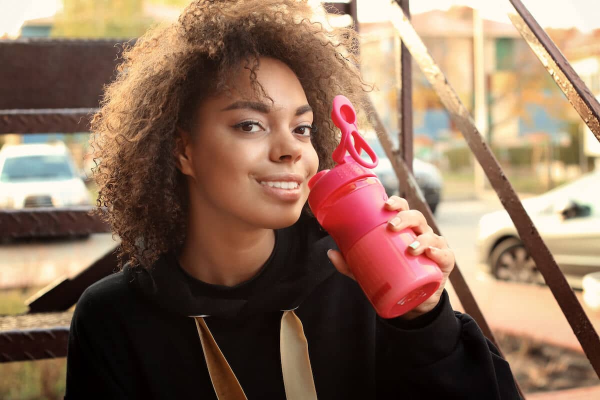 Woman about to drink from her tumbler