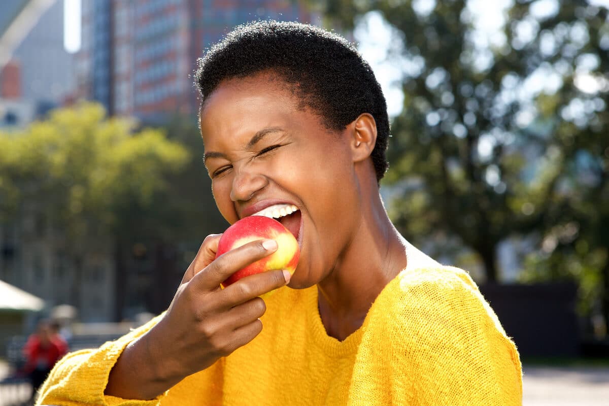 Nutrition goals: woman biting an apple