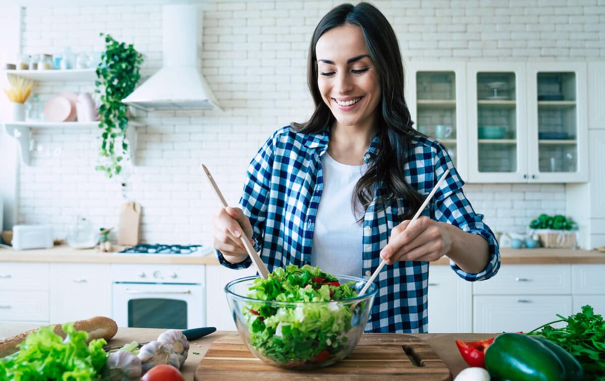 Woman mixing salad