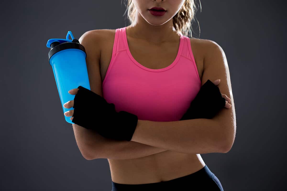 Athlete holding a protein shake bottle