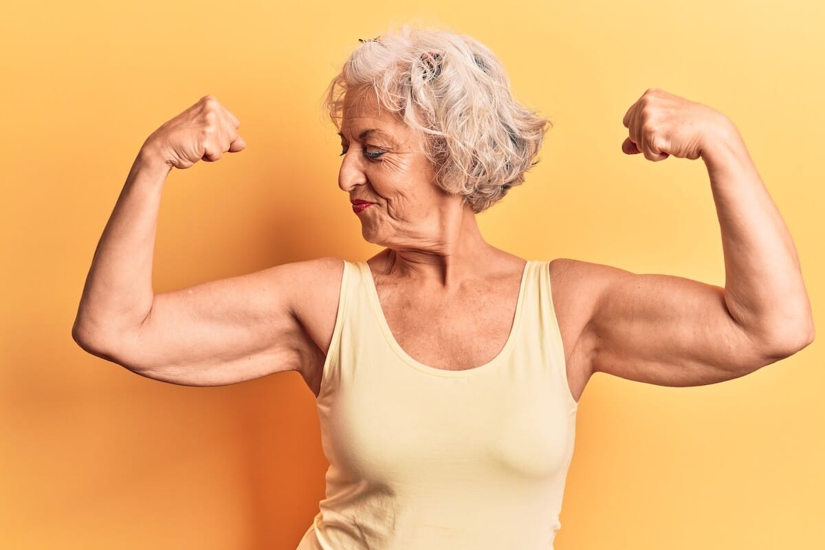 Best protein for seniors: elderly woman flexing her muscles