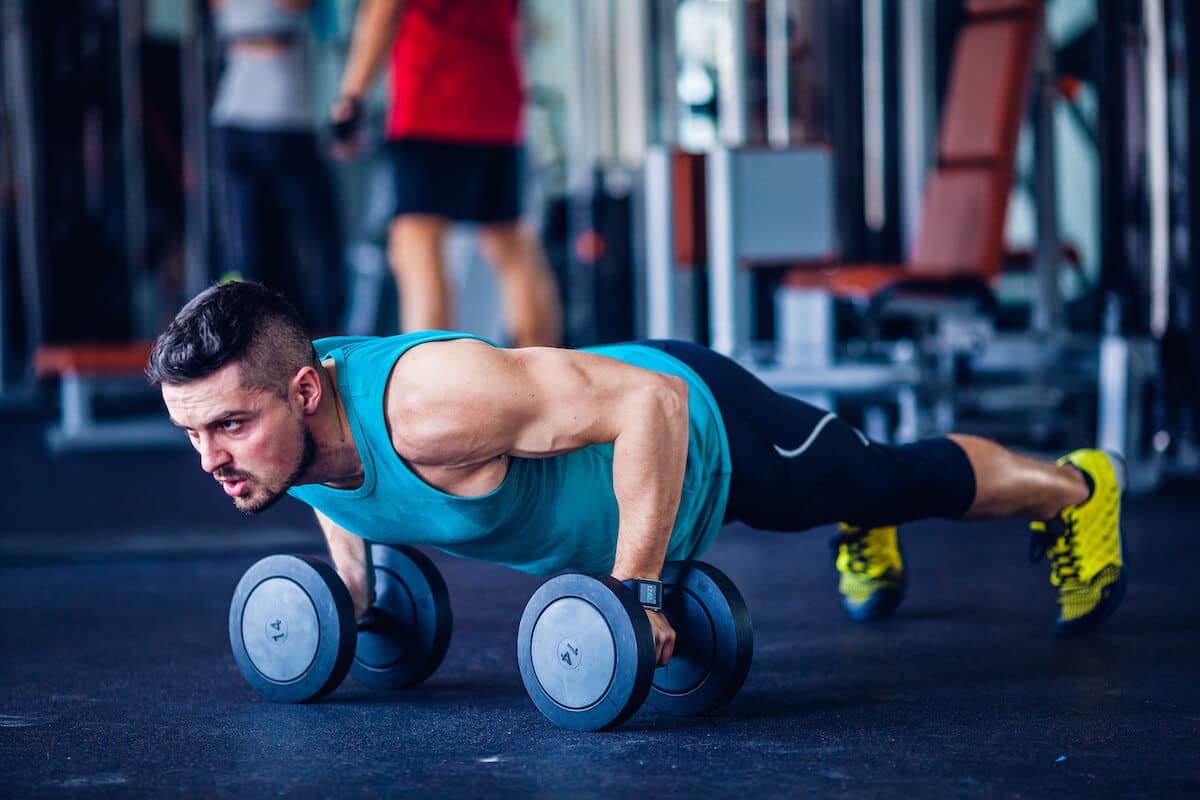 Man doing push-ups with dumbbells