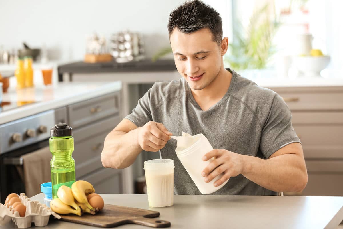 Pea protein amino acid profile: man happily making protein shake
