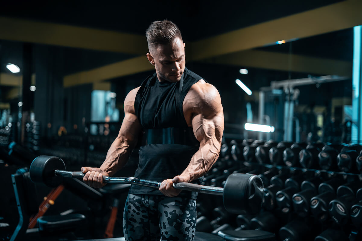 Man doing biceps curls using a barbell