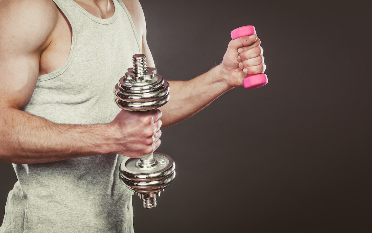 More reps or more weight: person using one light dumbbell and one heavy dumbbell