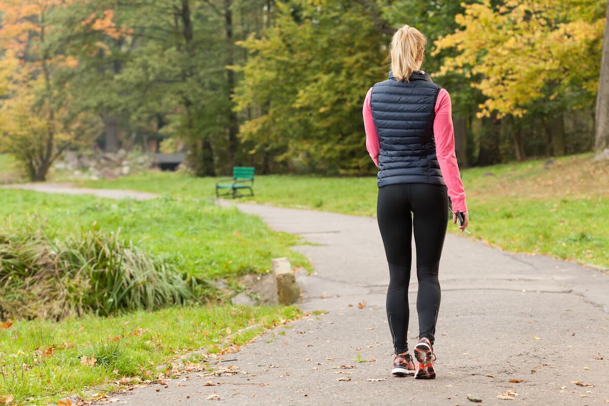 Low intensity cardio: woman walking at the park