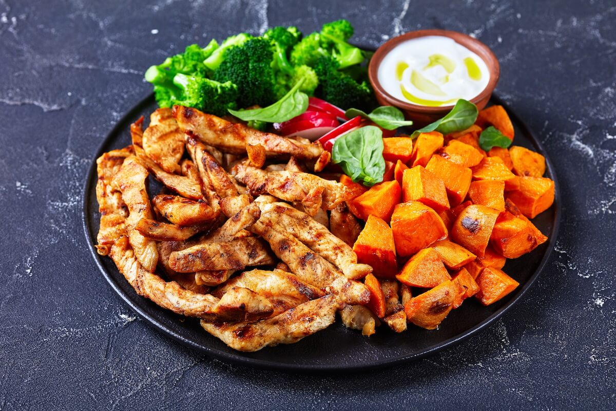 Chicken strips with sweet potatoes and broccoli on a plate