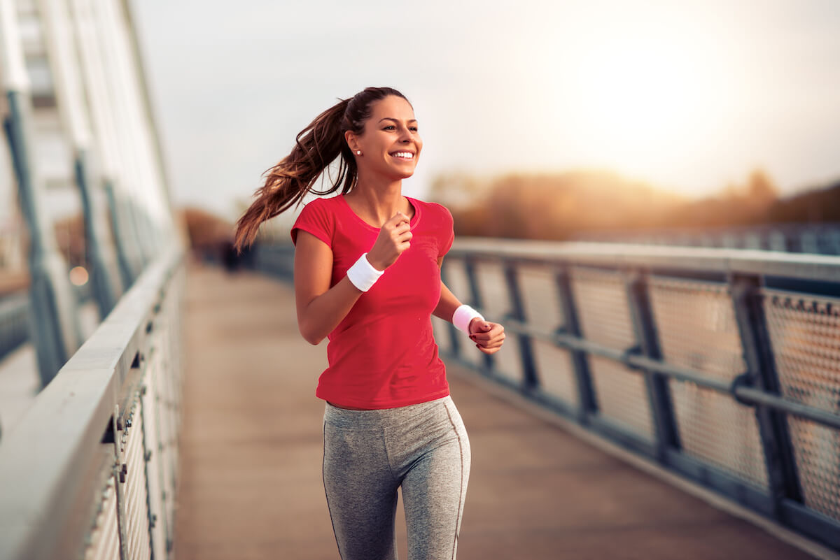 Happy woman jogging outside