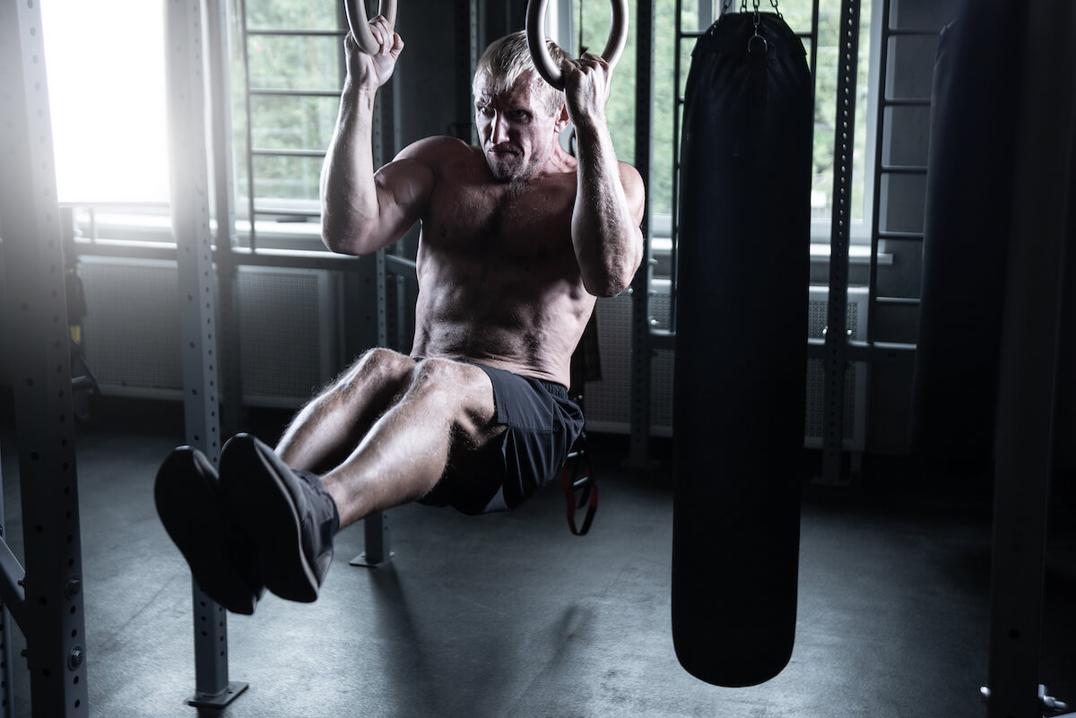 Metabolic conditioning: man doing some hanging leg raises