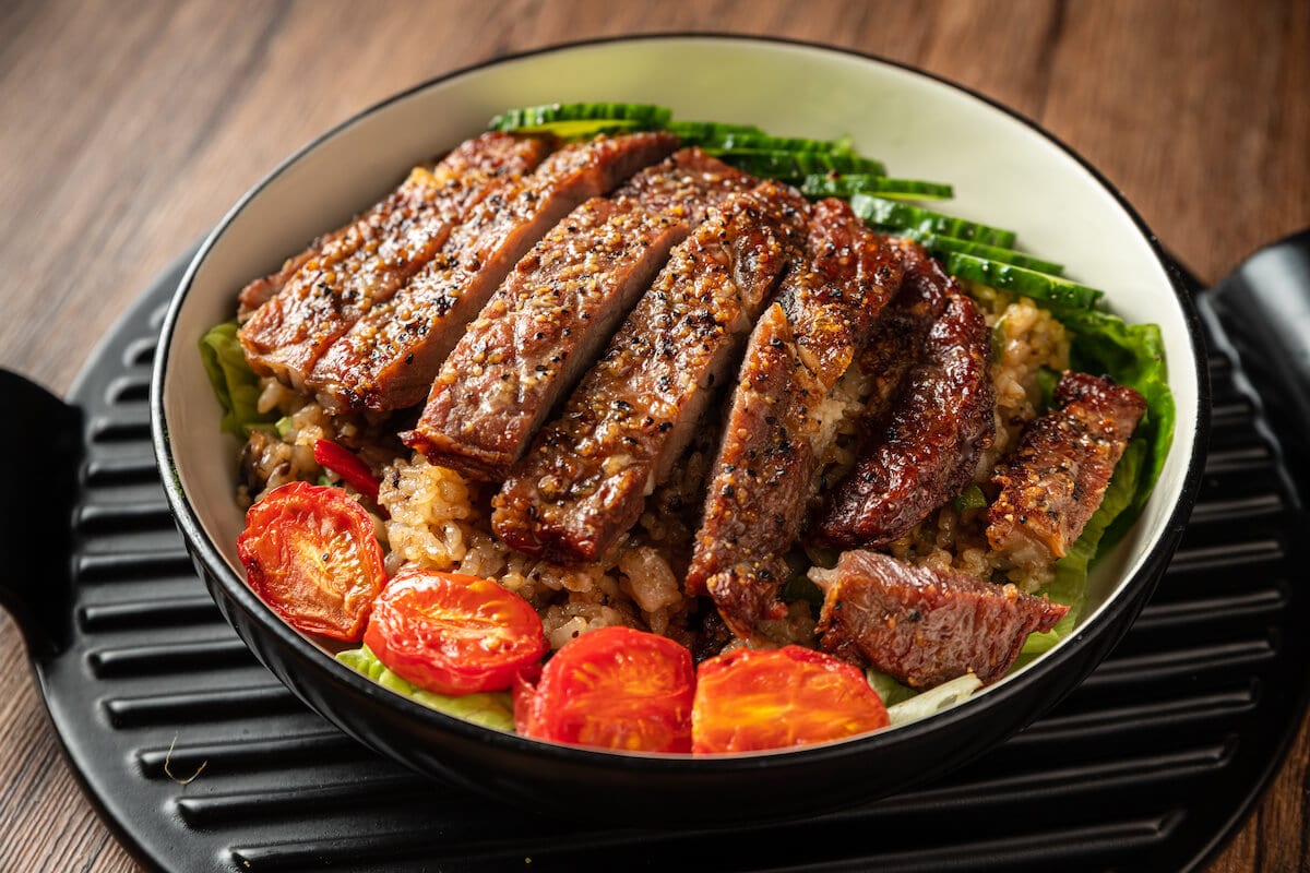 Pre workout meals: pork chop with tomatoes and rice in a bowl