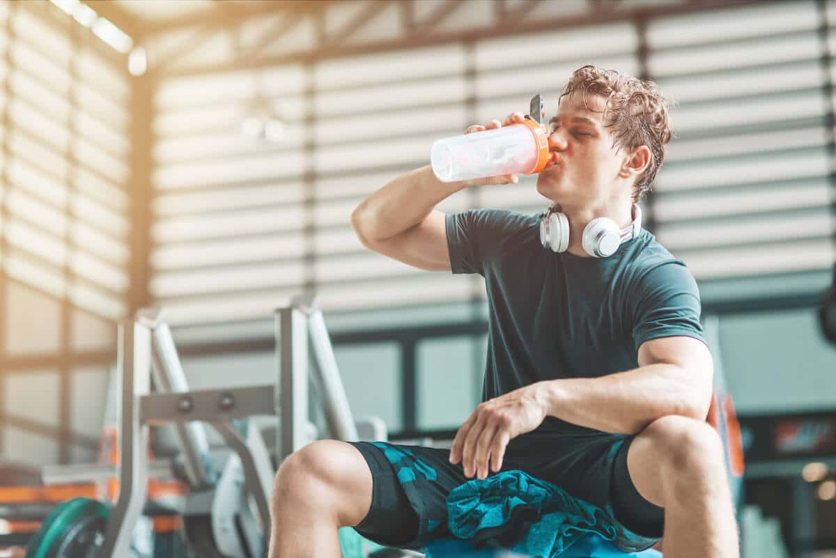 Tired man drinking from his tumbler