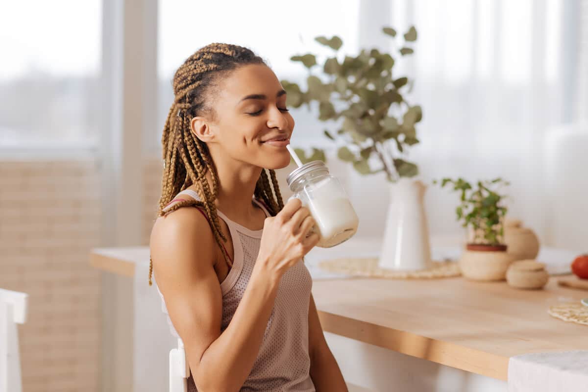 Woman happily drinking a protein shake