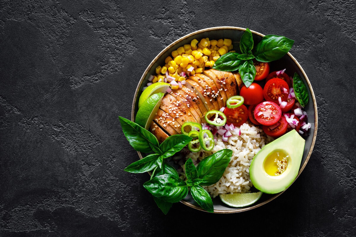 Grilled chicken with fruits and veggies in a bowl