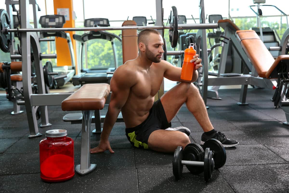 When to take protein powder: man holding his tumbler after working out