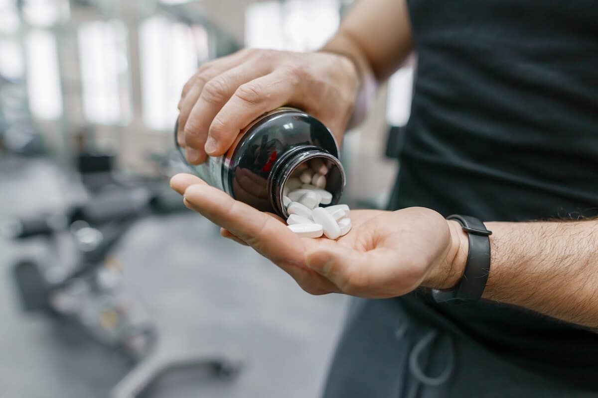 Person getting supplements from a jar