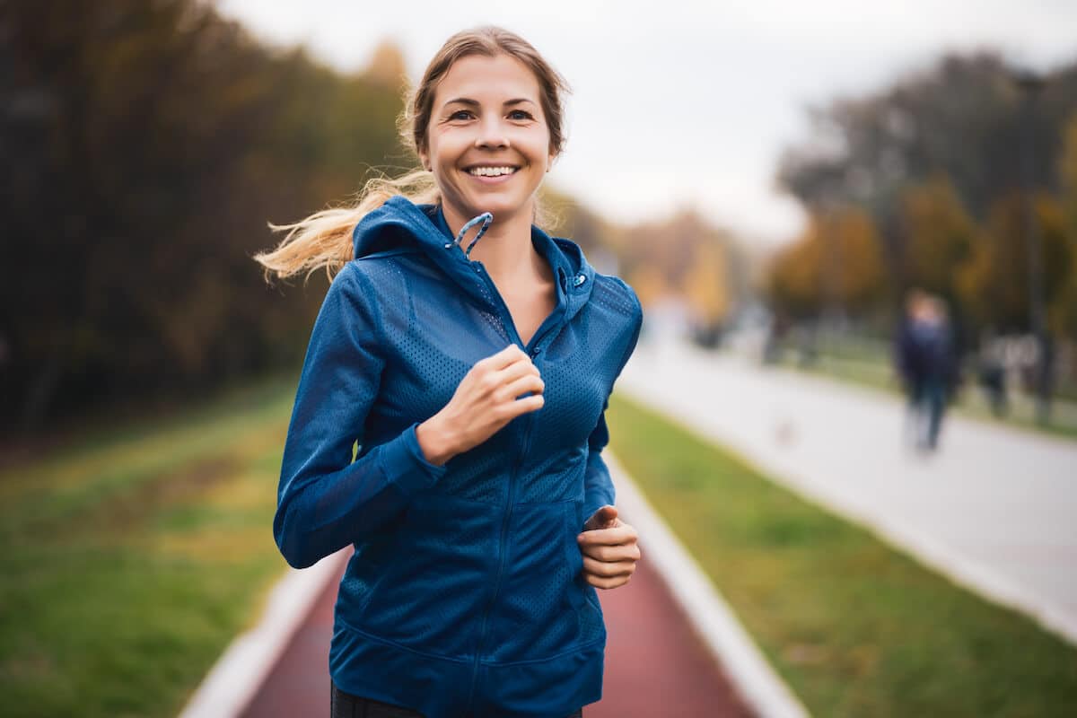 Best amino acids for women: woman jogging outside