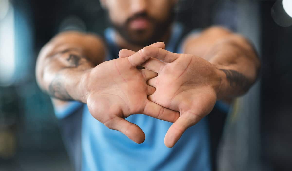 Muscle recovery: close up shot of a person's hand while stretching