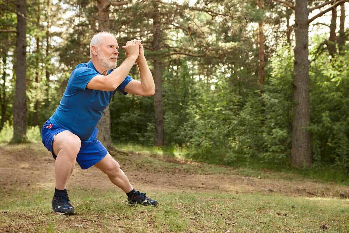 Supplements for building muscle after 60: senior man working out outside