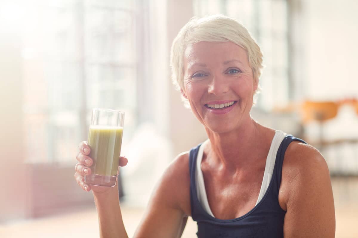 Senior woman holding a glass of juice