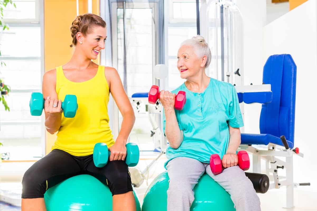 Young woman and a senior woman working out together