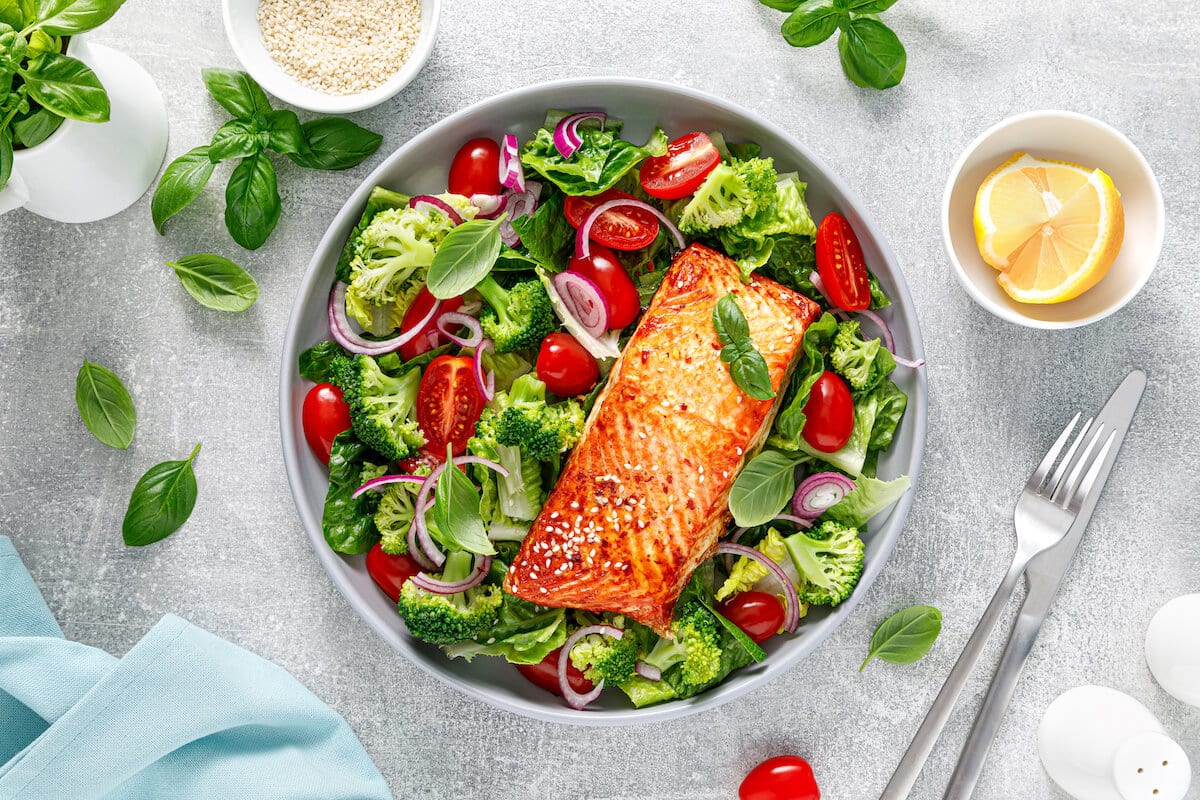 High protein low calorie foods: vegetable salad with a salmon in a bowl