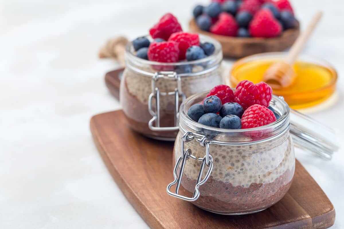 Chia seed pudding with berries on glass jars