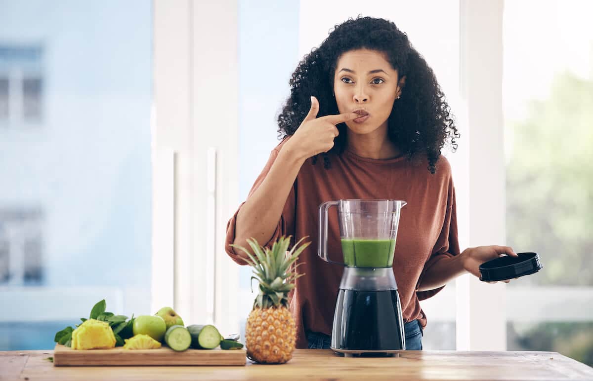 High protein breakfast: woman tasting her smoothie